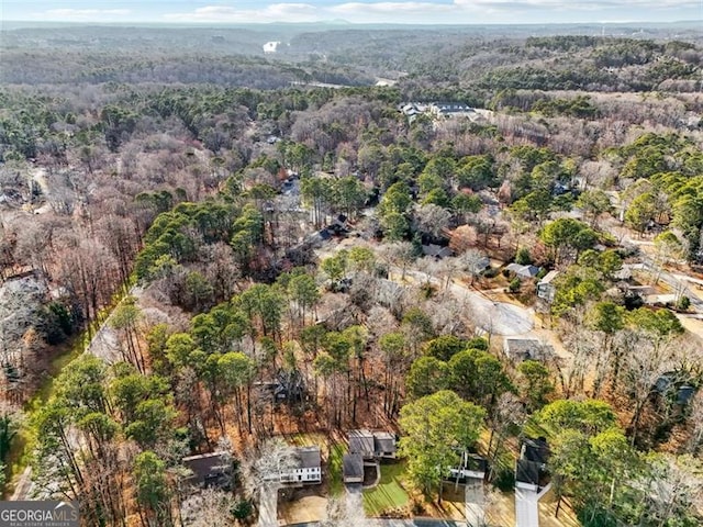 drone / aerial view with a wooded view