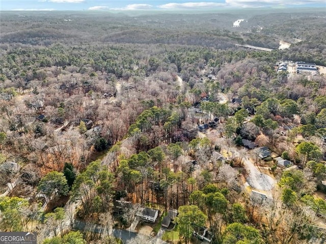 drone / aerial view with a wooded view