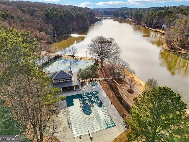 birds eye view of property with a water view and a view of trees