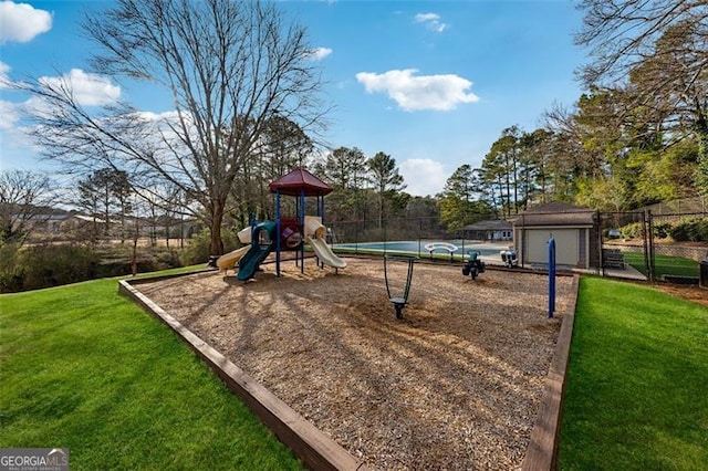 community jungle gym featuring an outbuilding, a yard, and fence