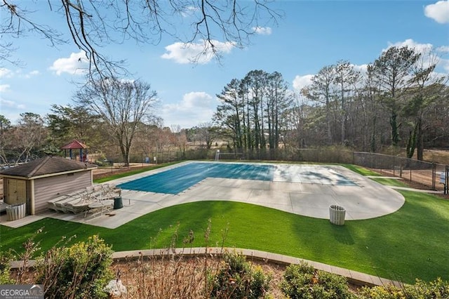 view of pool with a patio, a lawn, fence, and a fenced in pool