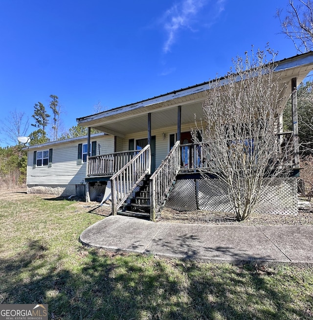 view of front of house with a front yard and stairway