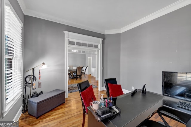 office area featuring ornamental molding, light wood-type flooring, and baseboards