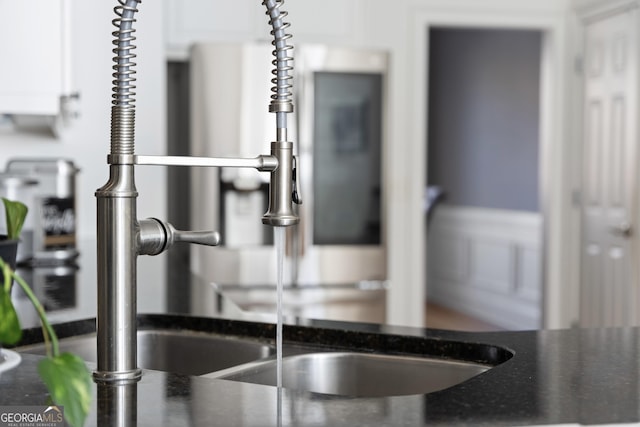 details featuring dark countertops and white cabinets