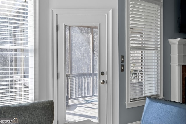 doorway featuring baseboards and a wealth of natural light