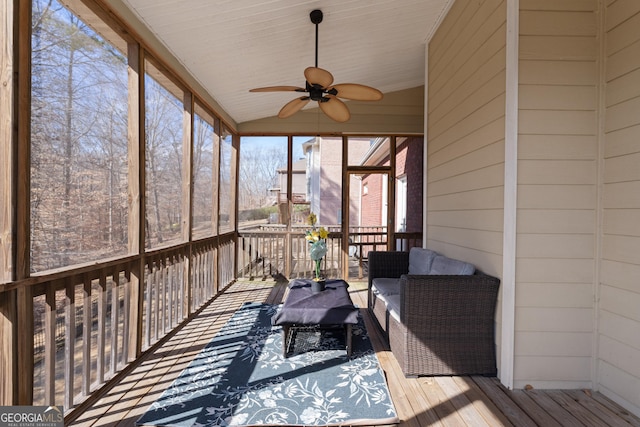 sunroom / solarium featuring lofted ceiling and a ceiling fan