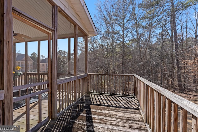 wooden deck featuring a sunroom and ceiling fan
