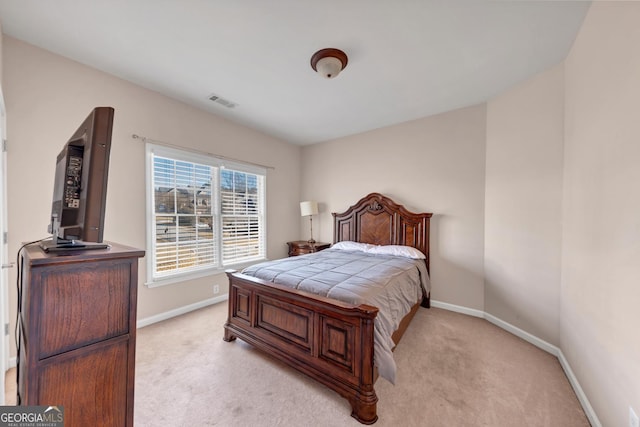 bedroom featuring light carpet, visible vents, and baseboards