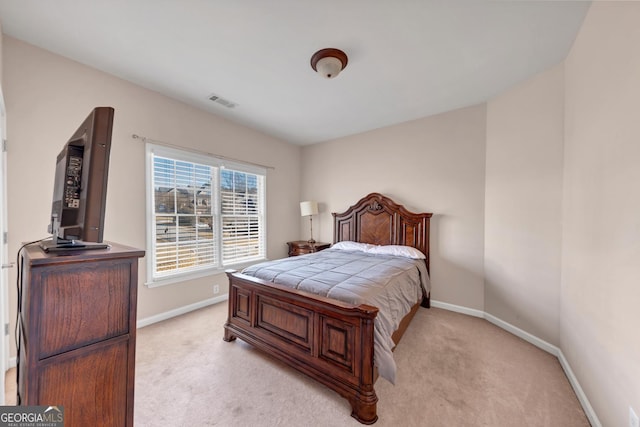bedroom featuring visible vents, baseboards, and light colored carpet