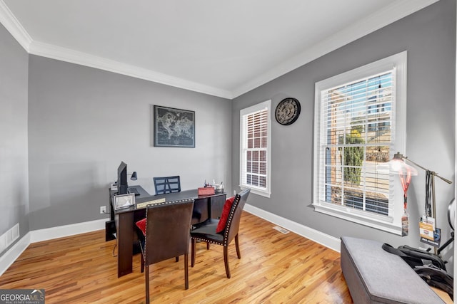 office space featuring ornamental molding, light wood-style flooring, and baseboards