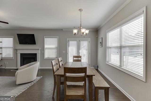 dining room with a fireplace, baseboards, and dark wood-style flooring