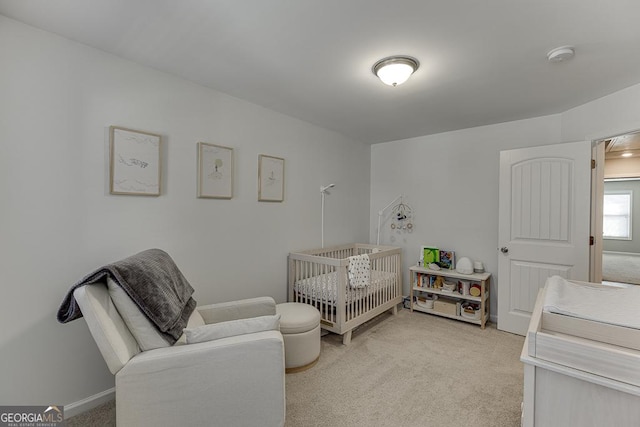 bedroom featuring light colored carpet and baseboards