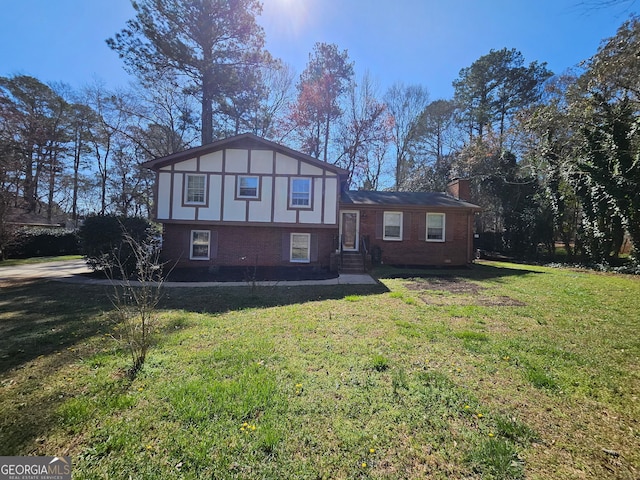 view of front facade featuring a front yard, brick siding, and a chimney