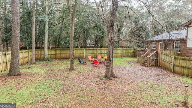 view of yard with a fenced backyard and a wooden deck