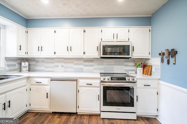 kitchen featuring electric stove, light countertops, dark wood finished floors, and white cabinets