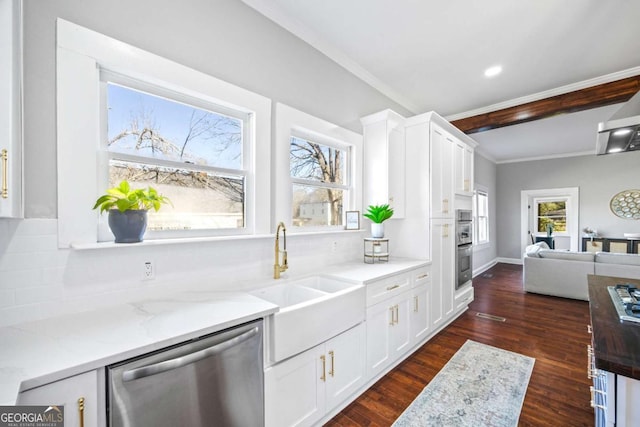 kitchen with stainless steel appliances, white cabinets, a sink, and light stone counters