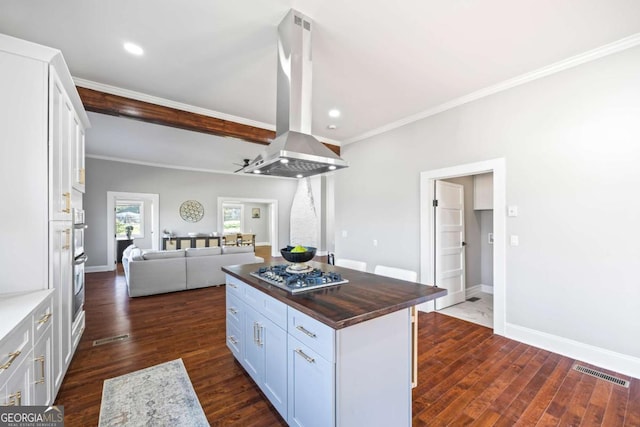 kitchen with island range hood, wood counters, open floor plan, a center island, and white cabinetry