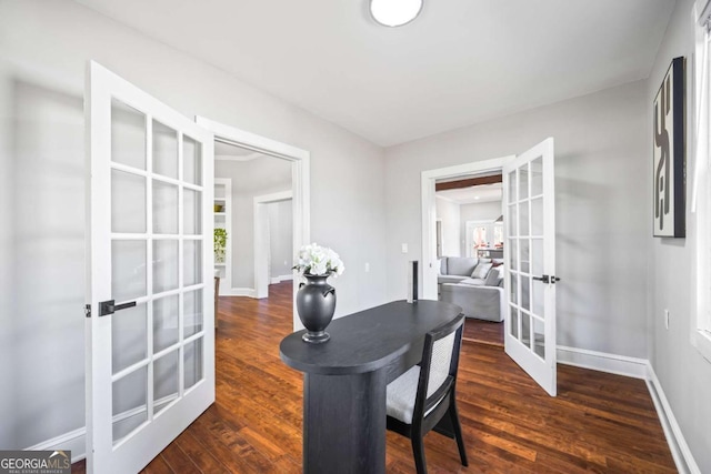 dining space with dark wood-type flooring, french doors, and baseboards