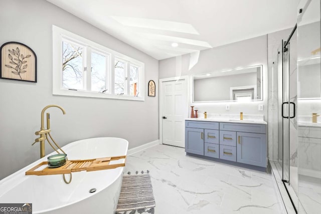 full bath featuring baseboards, a freestanding bath, marble finish floor, a marble finish shower, and double vanity