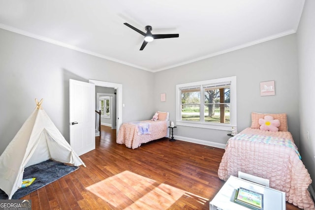 bedroom featuring crown molding, multiple windows, baseboards, and dark wood-style flooring