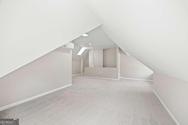 additional living space featuring lofted ceiling, light colored carpet, and baseboards