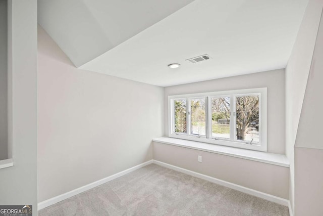 spare room with light carpet, visible vents, and baseboards