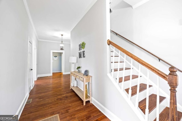 stairs featuring ornamental molding, visible vents, baseboards, and wood finished floors