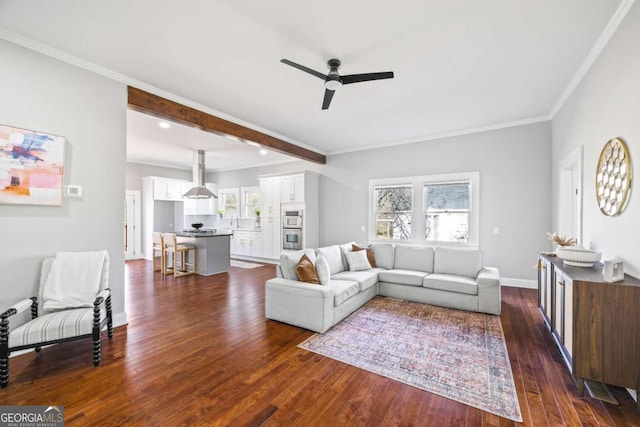 living area with baseboards, crown molding, a ceiling fan, and dark wood-style flooring