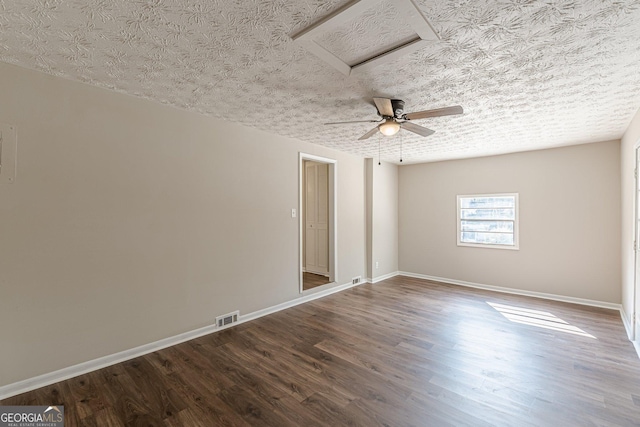 spare room with baseboards, a textured ceiling, visible vents, and wood finished floors