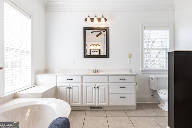 full bathroom featuring baseboards, toilet, tile patterned floors, vanity, and a bath