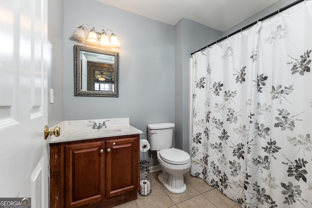 full bathroom with toilet, curtained shower, vanity, and tile patterned floors