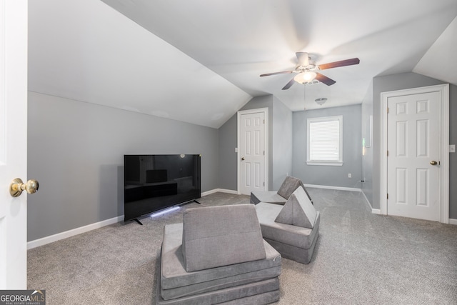 living area with carpet floors, ceiling fan, baseboards, and lofted ceiling