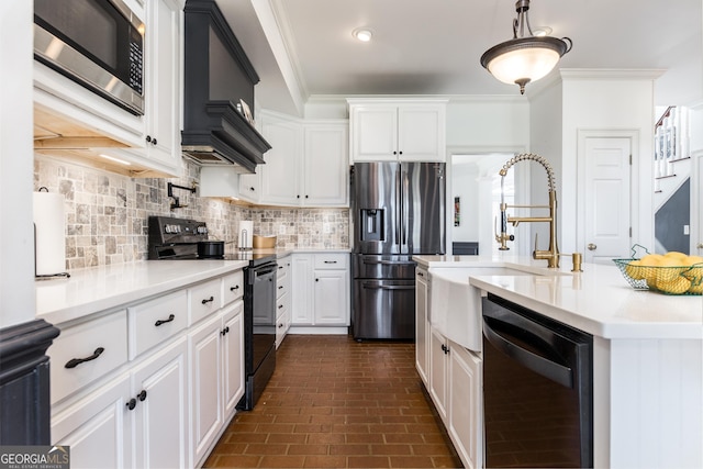 kitchen with crown molding, white cabinets, light countertops, black appliances, and pendant lighting