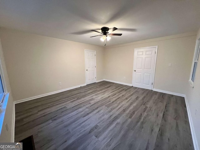 unfurnished bedroom with ceiling fan, dark wood finished floors, and baseboards