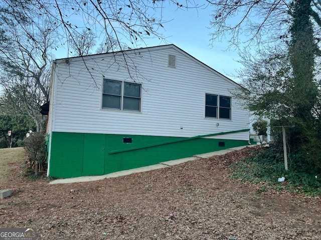 view of home's exterior with crawl space