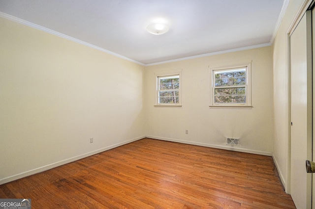 unfurnished bedroom featuring light wood-type flooring, a closet, crown molding, and baseboards