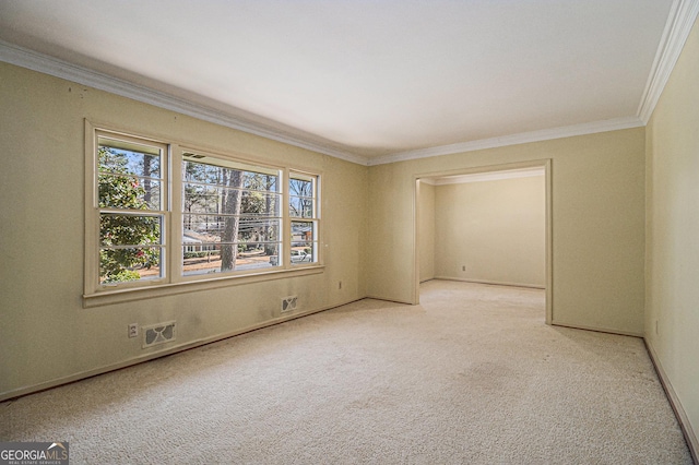 empty room featuring light carpet, baseboards, visible vents, and ornamental molding