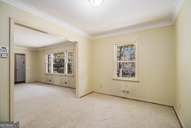 unfurnished room featuring light carpet, ornamental molding, and a healthy amount of sunlight