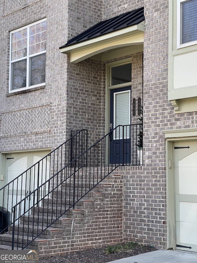 property entrance featuring brick siding