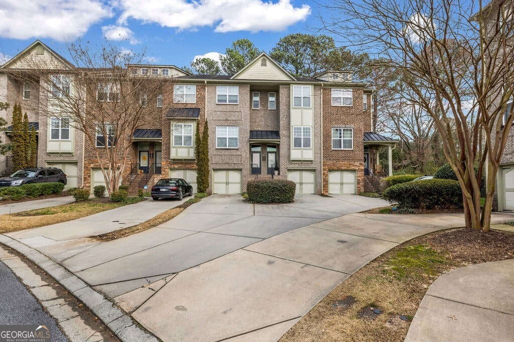 1992 Cobblestone Cir NE, Brookhaven, GA 30319 - view of building exterior with driveway and a garage