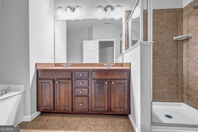 full bath with double vanity, visible vents, tile patterned flooring, a tile shower, and a sink