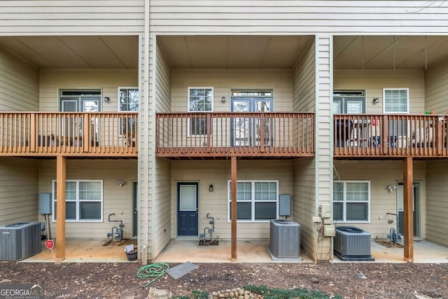 rear view of house featuring central AC unit