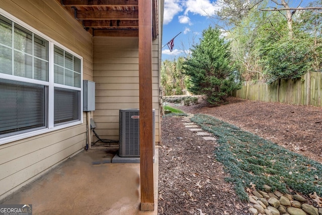 view of yard with fence and central AC unit