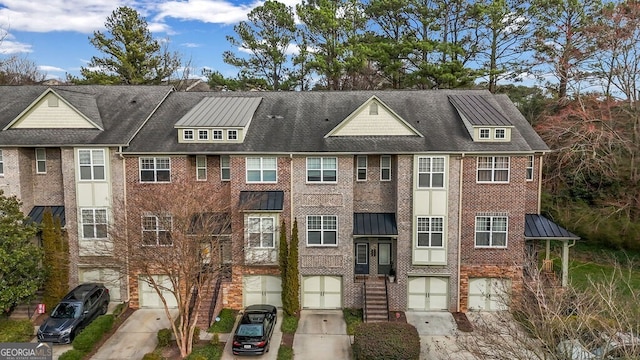 view of building exterior with driveway and an attached garage