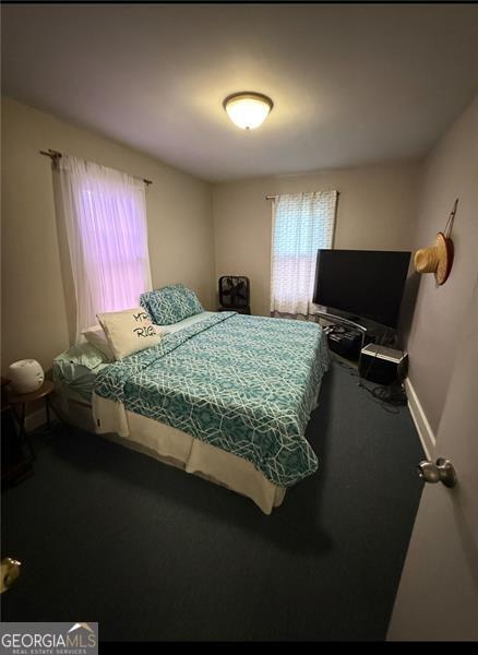 bedroom with carpet floors and baseboards