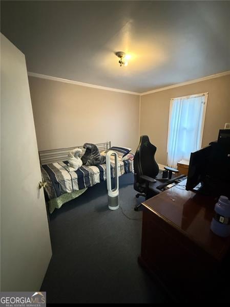 bedroom featuring ornamental molding and carpet flooring