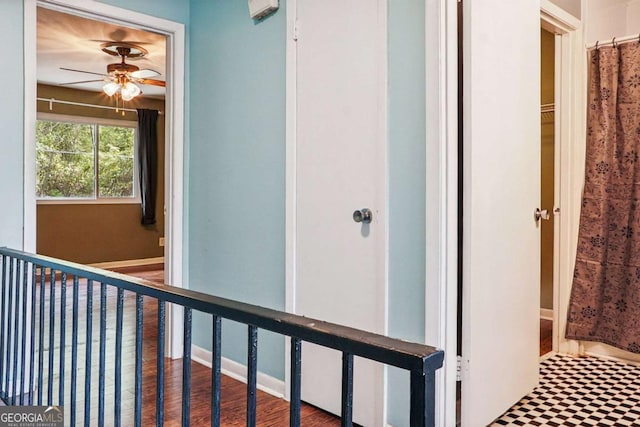 hallway with baseboards and wood finished floors