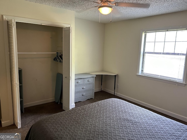 bedroom featuring a textured ceiling, ceiling fan, a closet, and baseboards