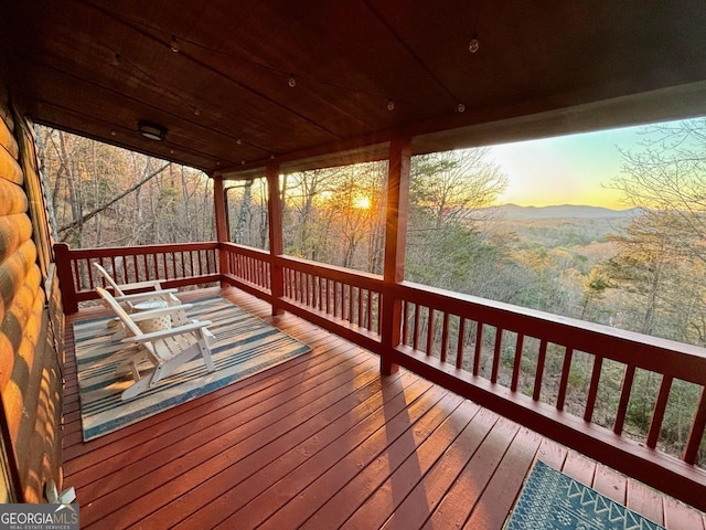 deck at dusk featuring a mountain view