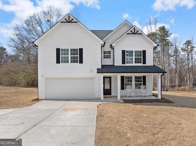 traditional home featuring a garage, a porch, concrete driveway, and roof with shingles